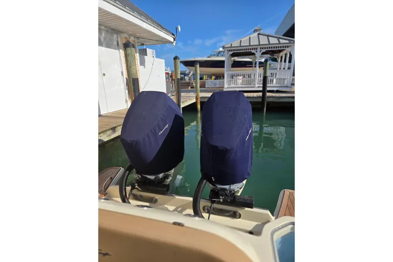 Slide: The Image of 2023 Chris-Craft Calypso 35 boat engines covered at dockside. - 28