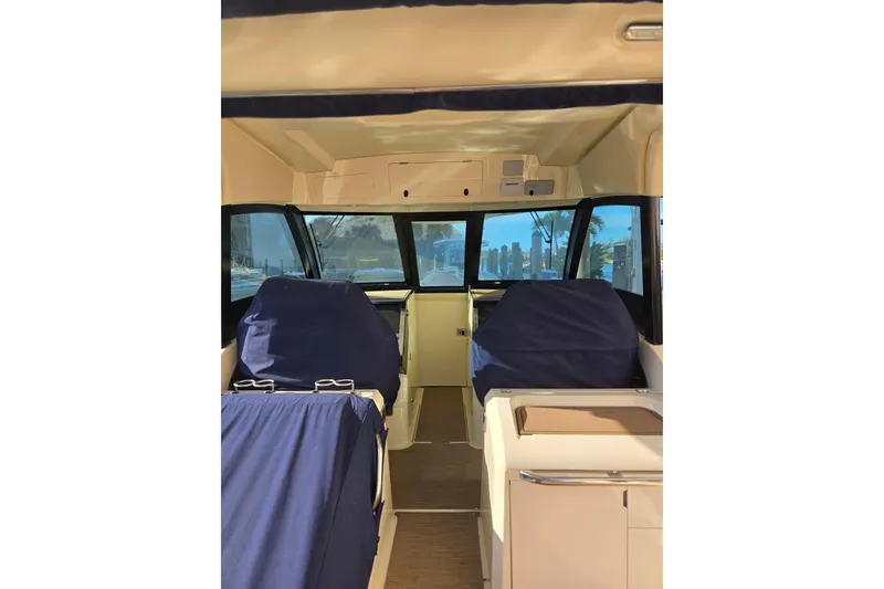 Slide: The Image of Interior view of 2023 Chris-Craft Calypso 35 boat, featuring covered seating and helm area. - 30
