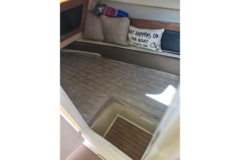 Slide: The Image of 2023 Chris-Craft Calypso 35 docked, covered, reflecting on calm water. - 35