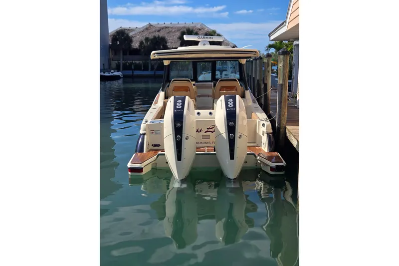 Slide: The Image of 2023 Chris-Craft Calypso 35 docked, featuring dual 400 V8 engines, in a serene marina setting. - 4