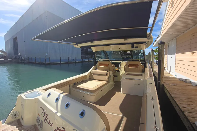 Slide: The Image of 2023 Chris-Craft Calypso 35 boat docked, featuring spacious seating and sunshade. - 5
