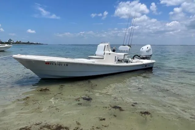 The Image of 2023 Abaco Skiff 20 boat in shallow water, clear sky, and calm sea. - 1
