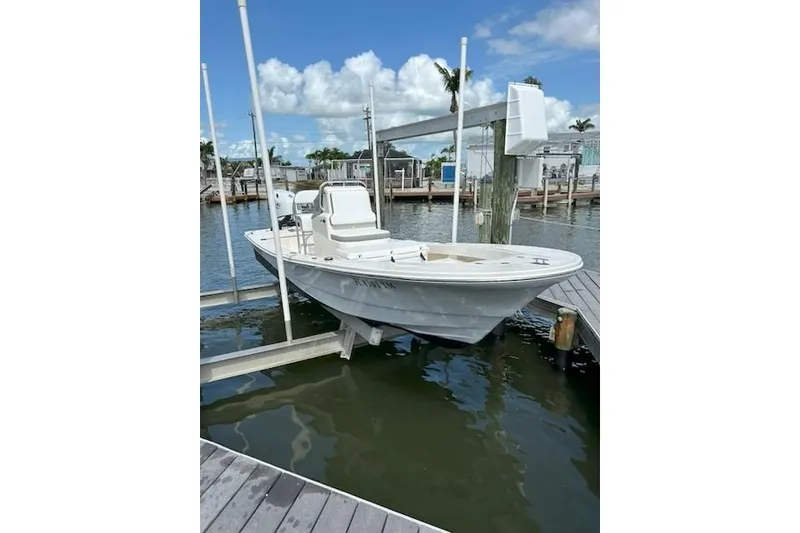 Slide: The Image of 2023 Abaco Skiff 20 boat docked at marina under clear blue sky. - 5