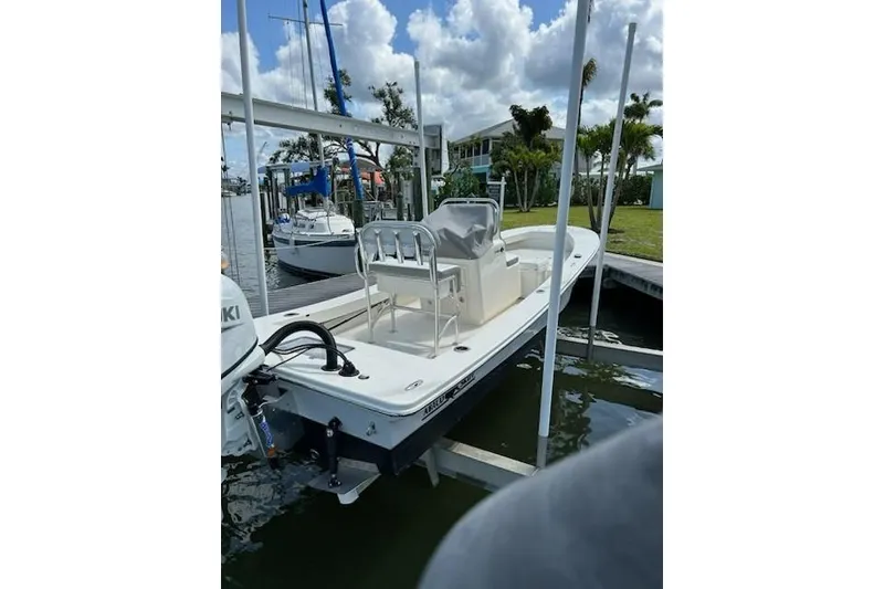 Slide: The Image of 2023 Abaco Skiff 20 boat docked, featuring sleek design and modern outboard motor. - 6