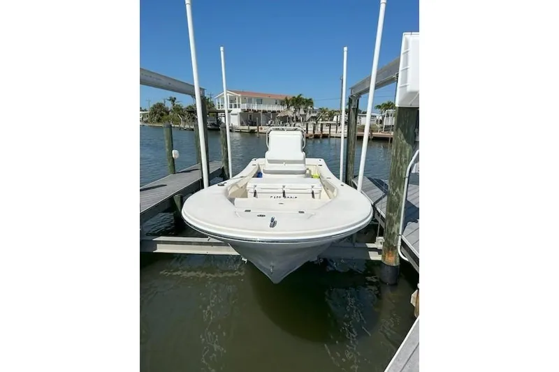 Slide: The Image of 2023 Abaco Skiff 20 boat docked on a sunny waterfront. - 7