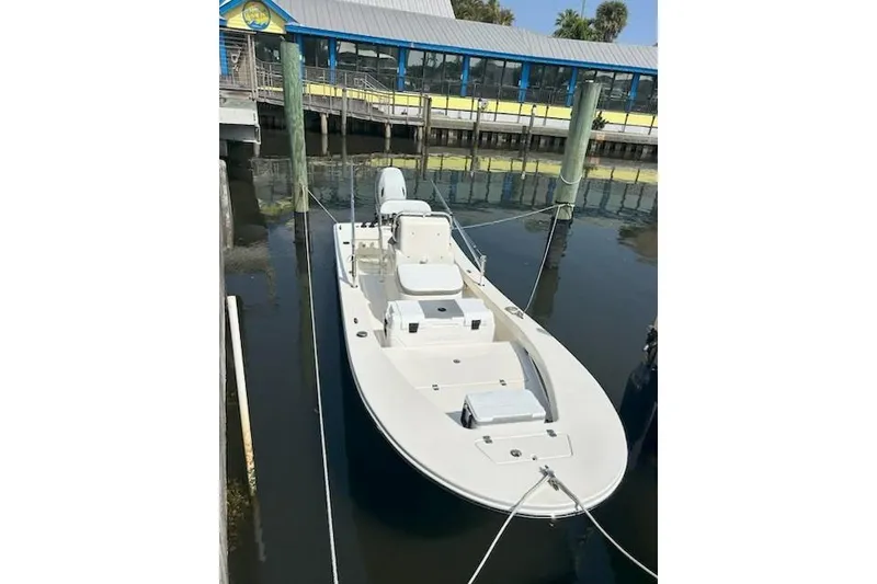 Slide: The Image of 2023 Abaco Skiff 20 boat docked at marina, calm water reflection. - 8