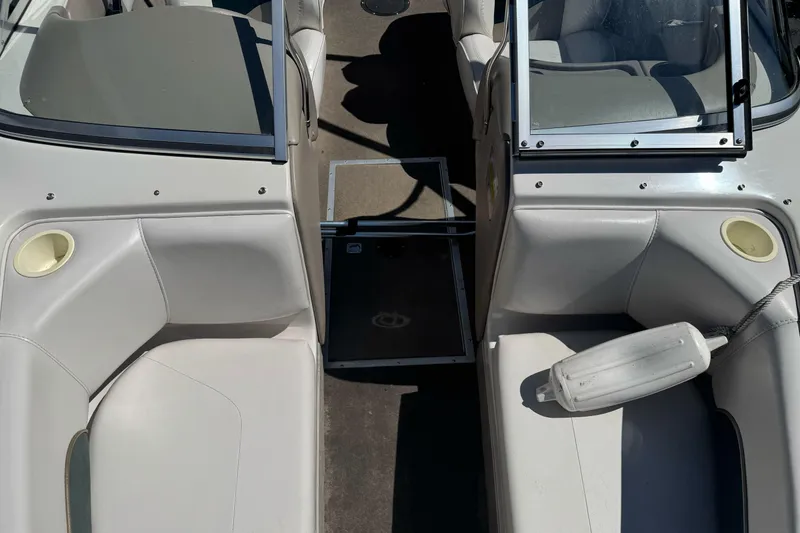 Slide: The Image of Interior of a 2001 Reinell 203 boat, featuring seating and open windshield. - 10