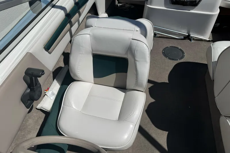 Slide: The Image of Interior of a 2001 Reinell 203 boat featuring white leather seating. - 11