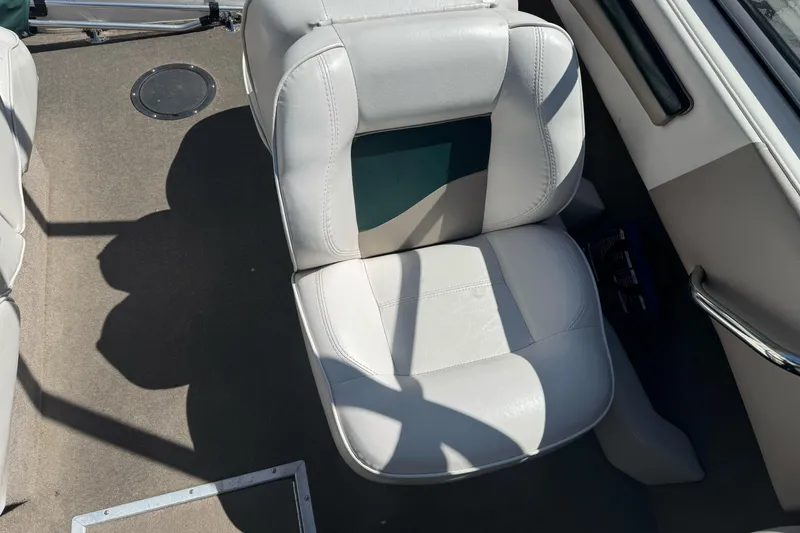 Slide: The Image of White leather seat in a 2001 Reinell 203 boat interior. - 12