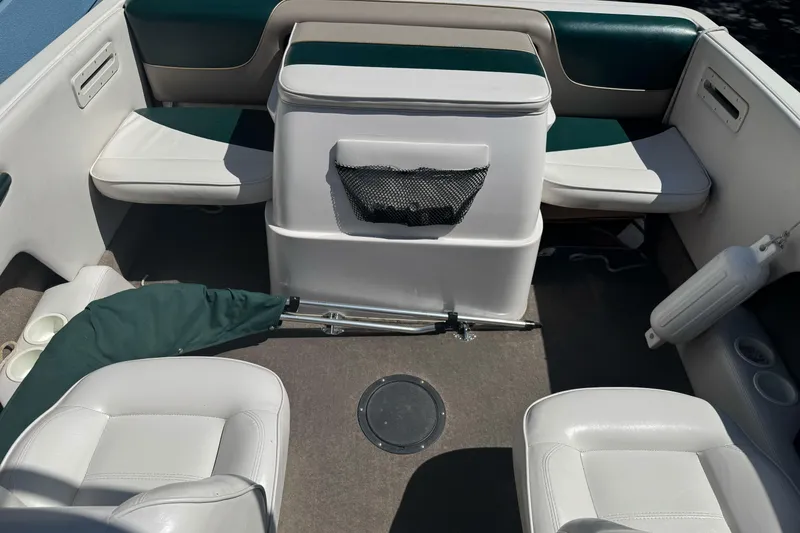 Slide: The Image of 2001 Reinell 203 boat interior with white seating and storage compartment. - 13
