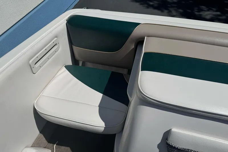 Slide: The Image of Interior seating of a 2001 Reinell 203 boat with green and white upholstery. - 14