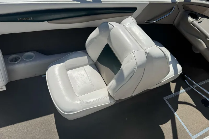 Slide: The Image of 2001 Reinell 203 boat interior with white leather seating and cup holders. - 16