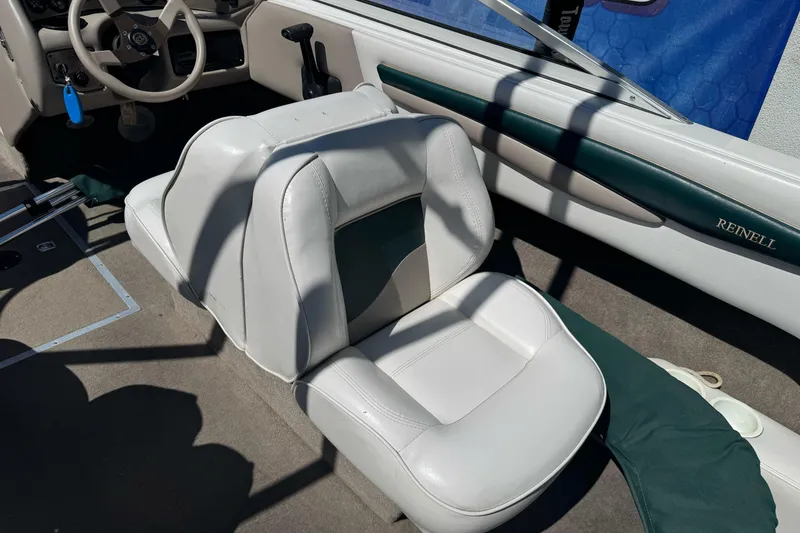Slide: The Image of Interior of a 2001 Reinell 203 boat with white and green seating. - 17