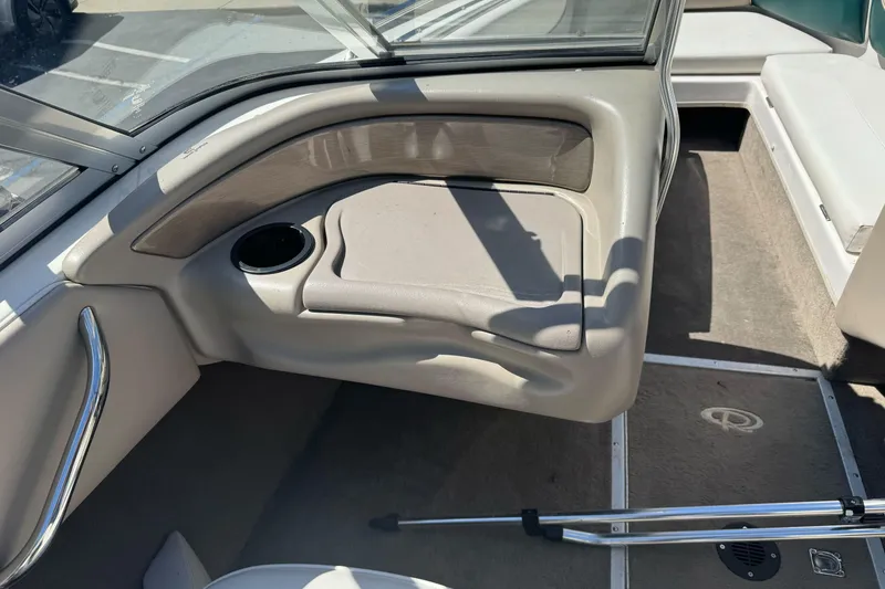Slide: The Image of Interior of a 2001 Reinell 203 boat, featuring seating and cup holder. - 21