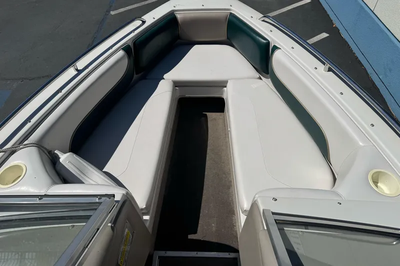 Slide: The Image of Interior view of a 2001 Reinell 203 boat with white and green seating. - 7