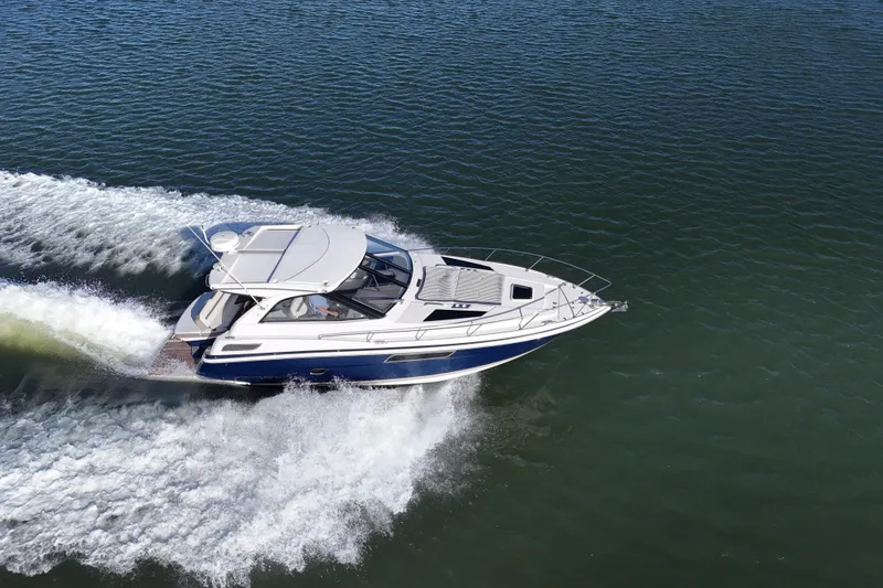 Slide: The Image of 2016 Regal 35 Sport Coupe cruising on open water, aerial view. - 13