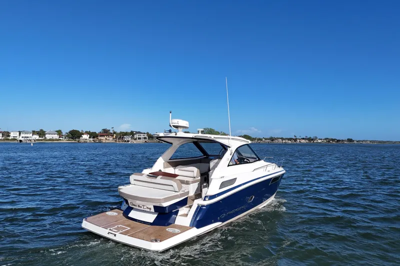 Slide: The Image of 2016 Regal 35 Sport Coupe cruising on a sunny day, near coastal homes. - 17