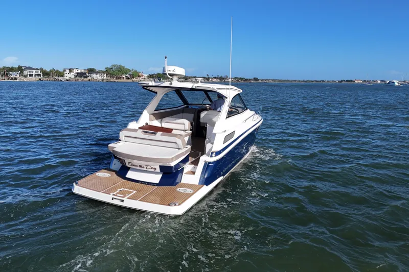 Slide: The Image of 2016 Regal 35 Sport Coupe cruising on a sunny day, showcasing sleek design and luxury. - 18