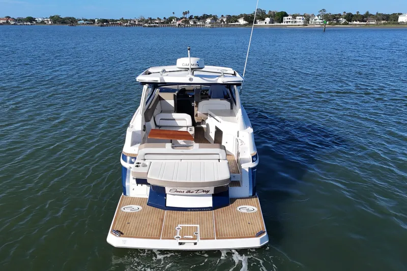 Slide: The Image of 2016 Regal 35 Sport Coupe on calm water, showcasing spacious deck and seating. - 20