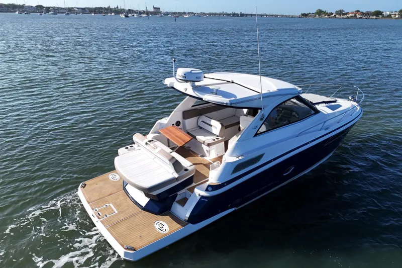 Slide: The Image of 2016 Regal 35 Sport Coupe cruising on a calm lake, showcasing sleek design and luxury features. - 21