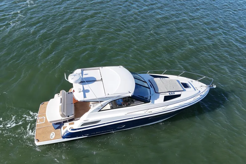 Slide: The Image of 2016 Regal 35 Sport Coupe cruising on open water, aerial view. - 25
