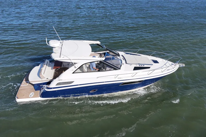 Slide: The Image of 2016 Regal 35 Sport Coupe cruising on open water, showcasing sleek design and luxury features. - 27