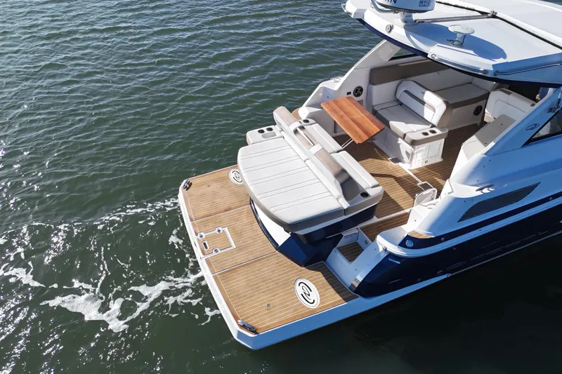 Slide: The Image of 2016 Regal 35 Sport Coupe yacht with spacious deck on calm water. - 30