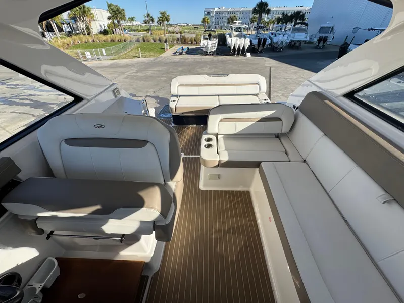 Slide: The Image of Interior of a 2016 Regal 35 Sport Coupe boat with white seating and wood flooring. - 34