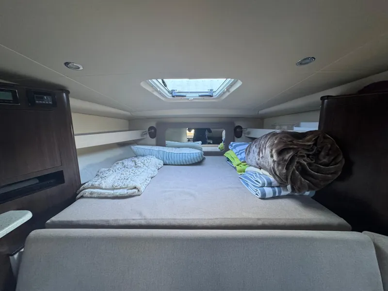 Slide: The Image of 2016 Regal 35 Sport Coupe cabin interior with skylight and cozy bedding. - 42