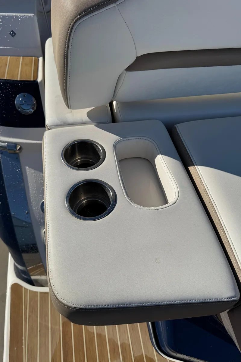 Slide: The Image of 2016 Regal 35 Sport Coupe boat interior with cup holders and seating. - 53