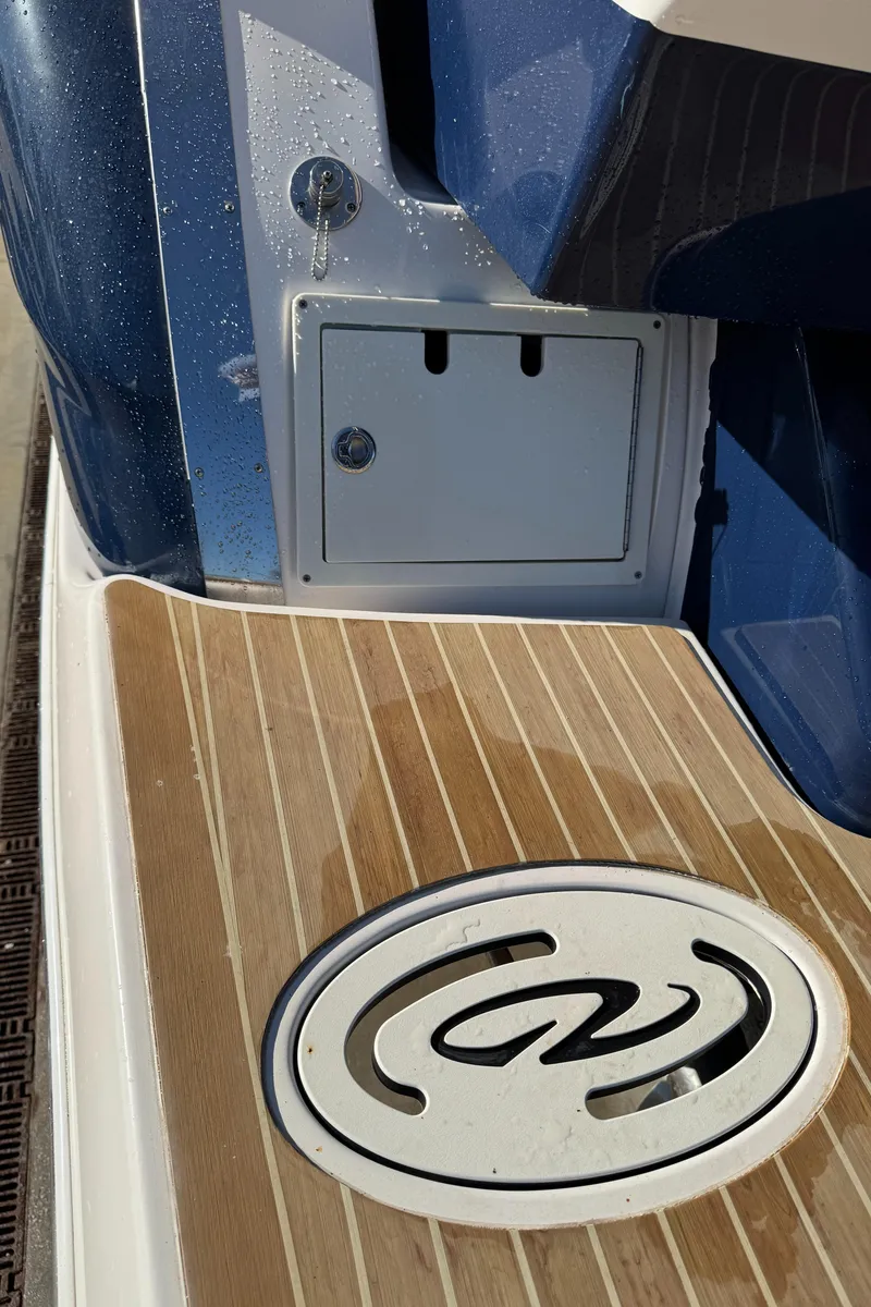 Slide: The Image of 2016 Regal 35 Sport Coupe boat deck with logo and storage compartment. - 55