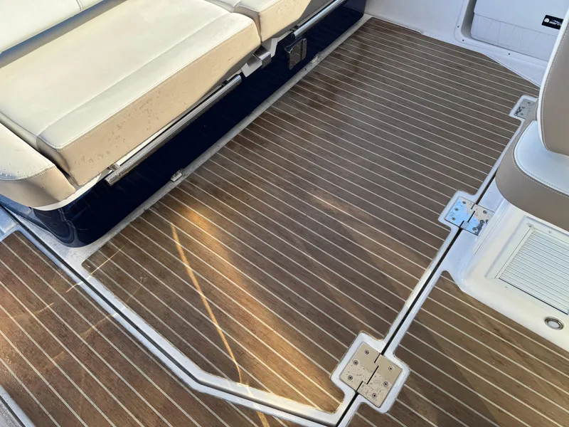 Slide: The Image of 2016 Regal 35 Sport Coupe interior with wood-patterned flooring and beige seating. - 57