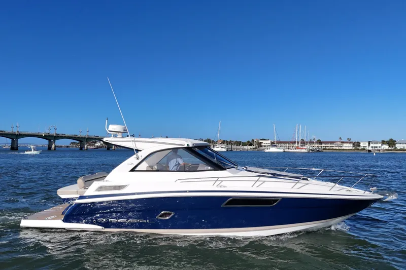 Slide: The Image of 2016 Regal 35 Sport Coupe cruising on a sunny day near a bridge. - 63