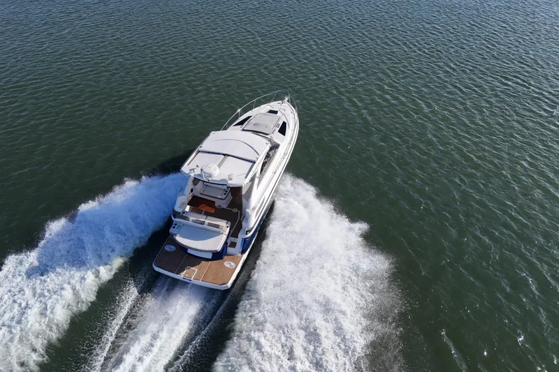 Slide: The Image of 2016 Regal 35 Sport Coupe cruising on open water, aerial view. - 73