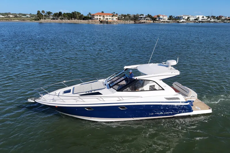 Slide: The Image of 2016 Regal 35 Sport Coupe cruising on a calm waterway. - 75