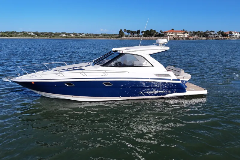 Slide: The Image of 2016 Regal 35 Sport Coupe cruising on a sunny day in calm waters. - 77