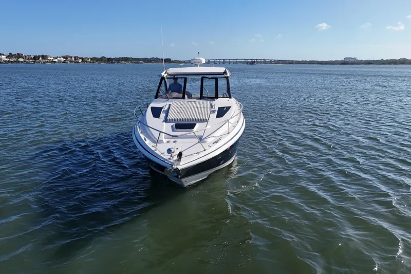 Slide: The Image of 2016 Regal 35 Sport Coupe cruising on a sunny day in open waters. - 79