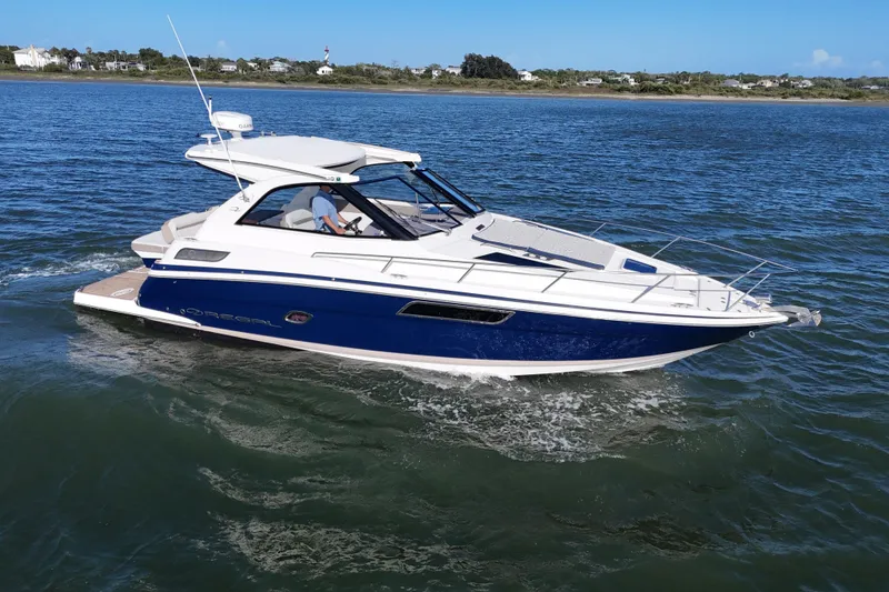 Slide: The Image of 2016 Regal 35 Sport Coupe cruising on open water, showcasing sleek design and luxury features. - 80