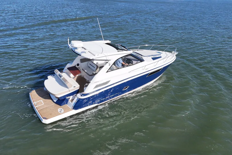 Slide: The Image of 2016 Regal 35 Sport Coupe cruising on open water, showcasing sleek design and luxury features. - 82