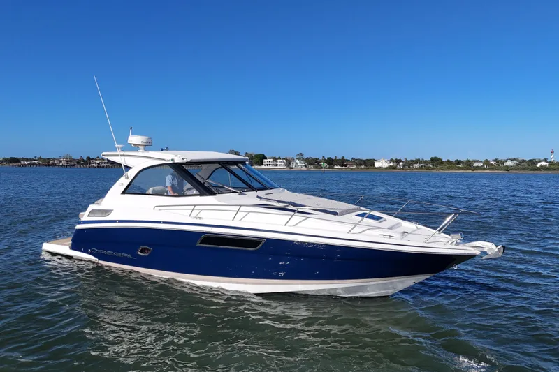 Slide: The Image of 2016 Regal 35 Sport Coupe cruising on a sunny day in calm waters. - 83