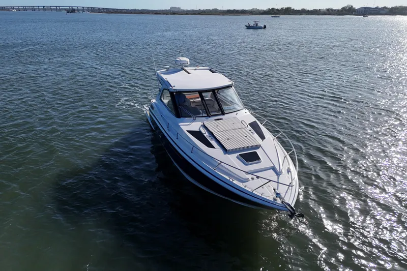 Slide: The Image of 2016 Regal 35 Sport Coupe cruising on a sunny, open waterway. - 85