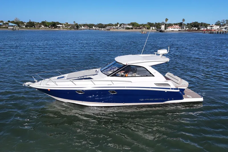 Slide: The Image of 2016 Regal 35 Sport Coupe cruising on a calm lake under clear blue skies. - 88
