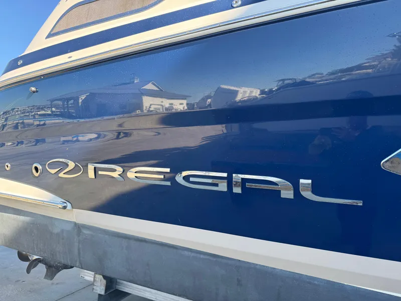 Slide: The Image of 2016 Regal 35 Sport Coupe boat with blue exterior and chrome logo. - 91