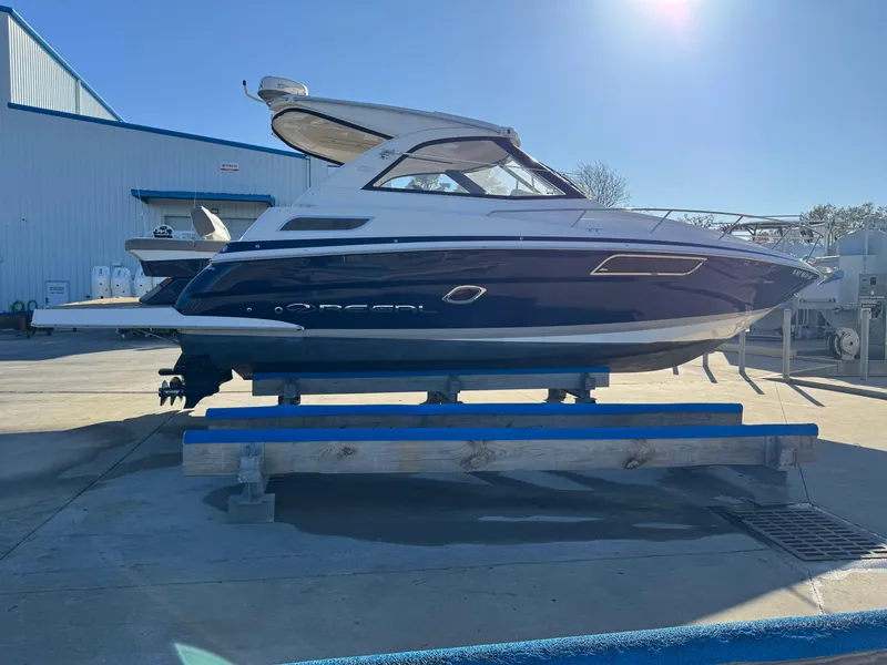 Slide: The Image of 2016 Regal 35 Sport Coupe boat on display at a marina. - 96