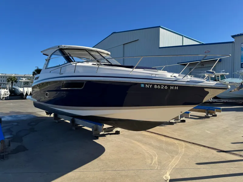 Slide: The Image of 2016 Regal 35 Sport Coupe boat on display in a marina setting. - 98