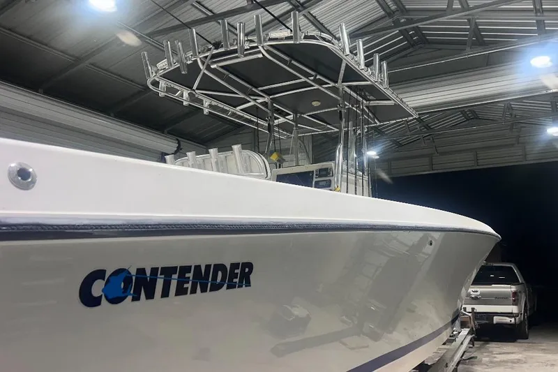 Slide: The Image of 2005 Contender 35 ST boat in a garage, side view with visible logo. - 12