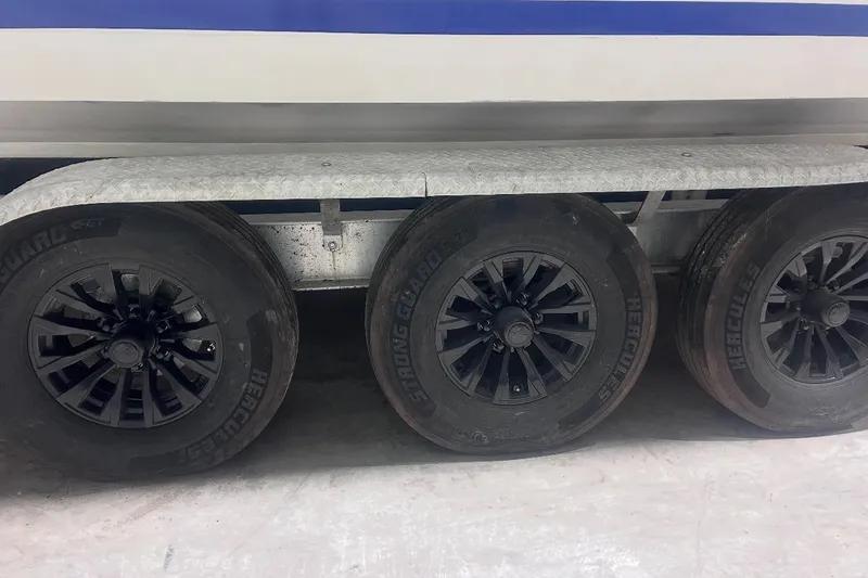 Slide: The Image of Trailer wheels of a 2005 Contender 35 ST boat, featuring Hercules tires. - 13
