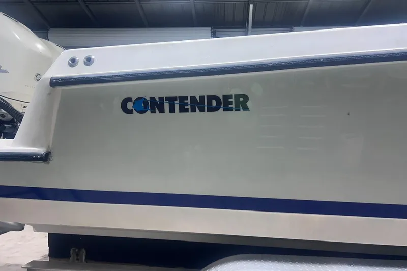 Slide: The Image of 2005 Contender 35 ST boat side view with logo in a garage setting. - 7