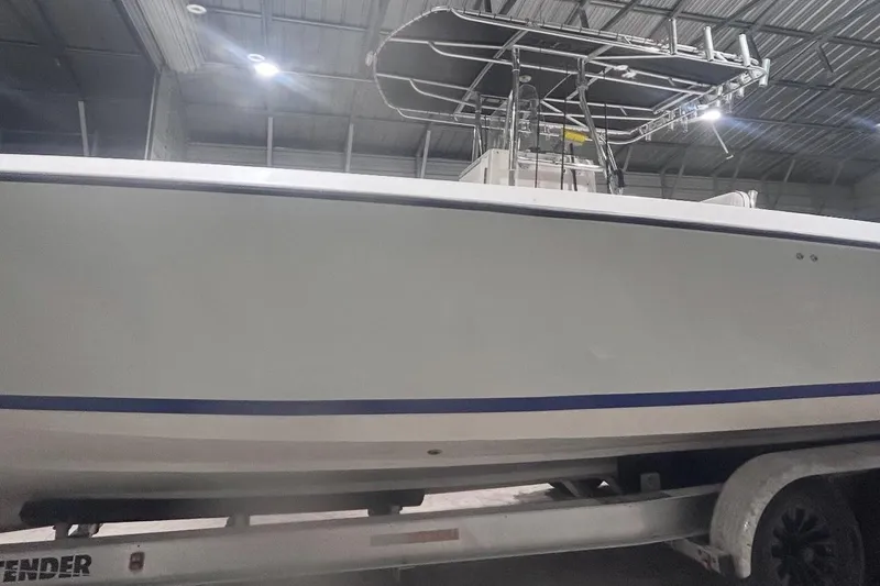 Slide: The Image of 2005 Contender 35 ST boat in a warehouse, side view on a trailer. - 9