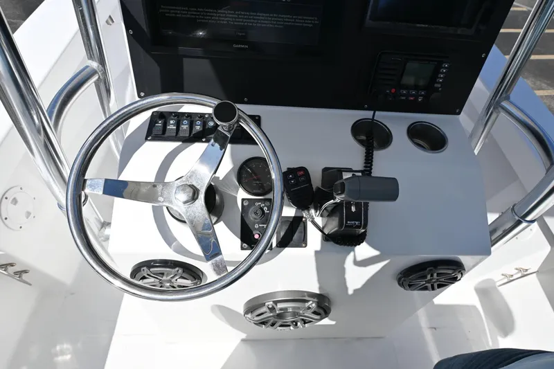Slide: The Image of Steering console of a 2017 Rambo 27 boat with controls and gauges. - 10